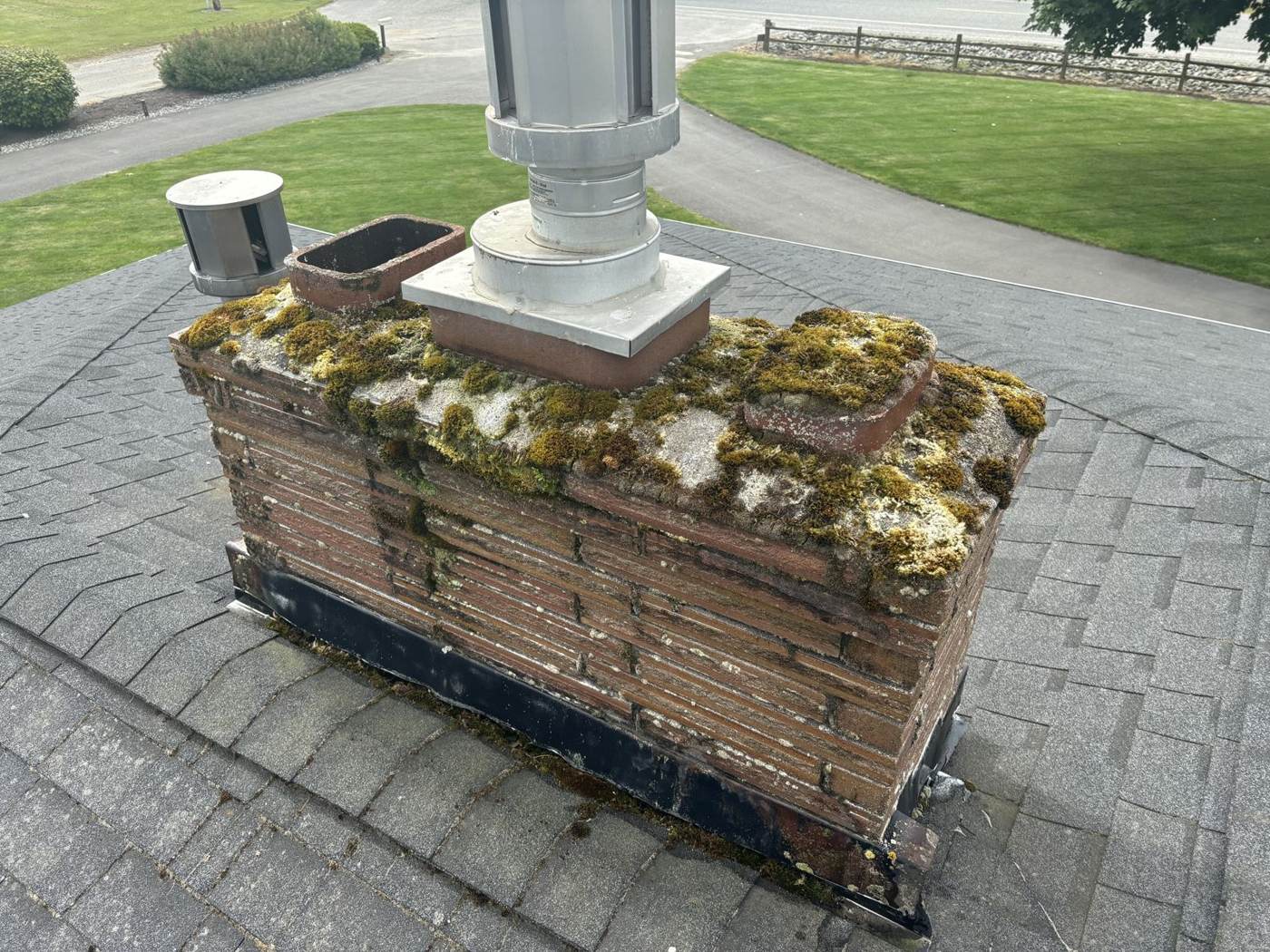 Moss covered chimney cap before cleaning